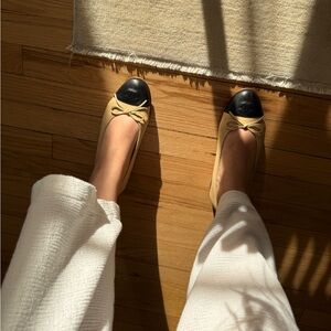 CHANEL Ballerina cap toe cream and black flats